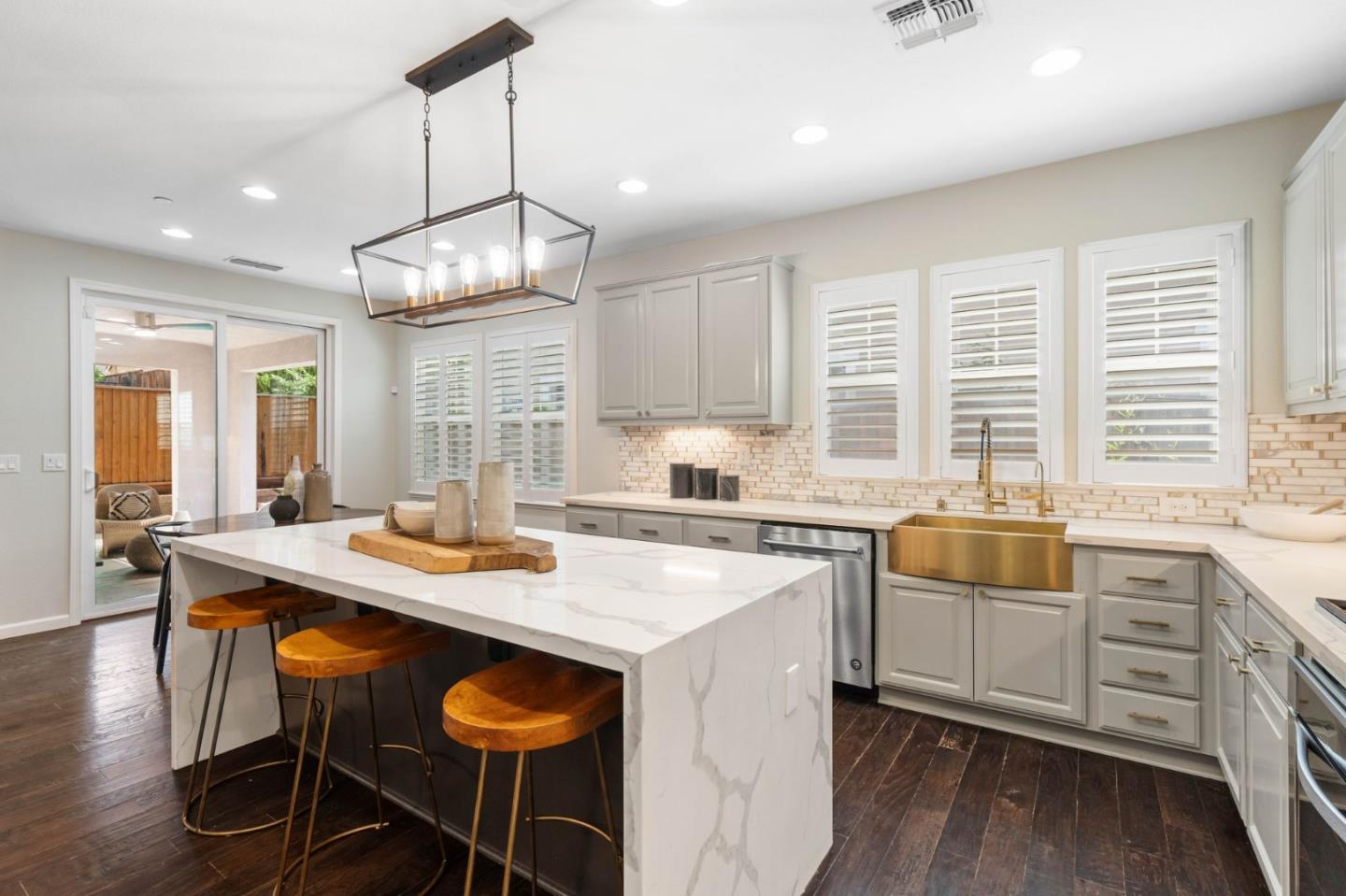 7026 Syrah Drive Dublin, CA 94568 - Photo 23 of 54 a kitchen with granite countertop a stove a sink a dining table and chairs