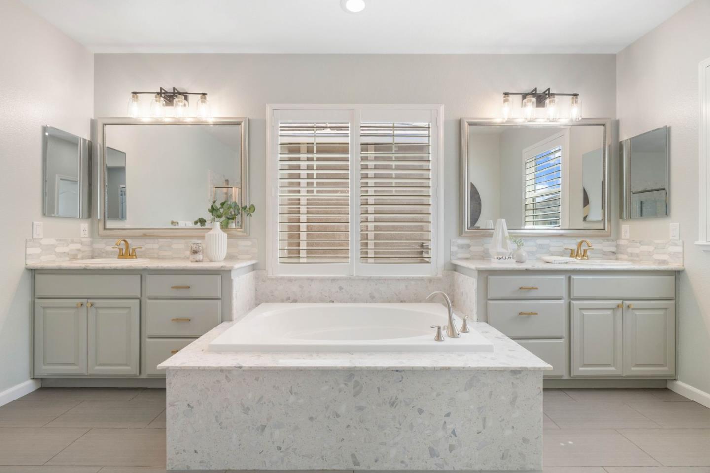 7026 Syrah Drive Dublin, CA 94568 - Photo 34 of 54 a spacious bathroom with a tub sink and mirror