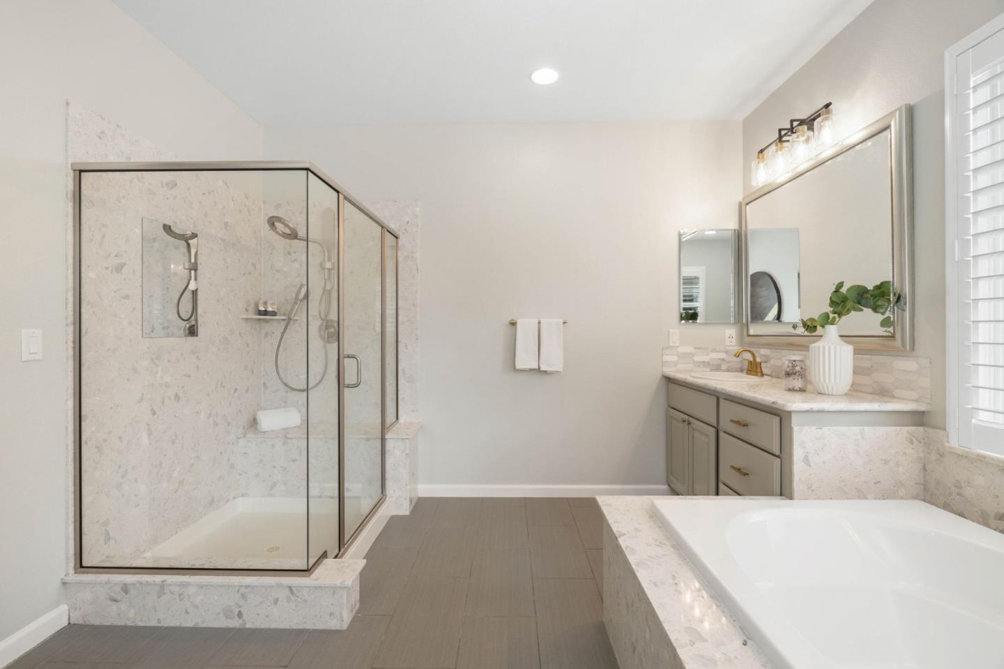 7026 Syrah Drive Dublin, CA 94568 - Photo 36 of 54 a bathroom with a tub sink shower and mirror