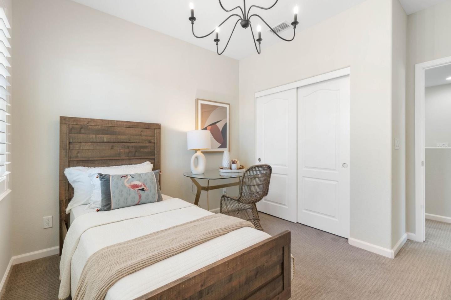 7026 Syrah Drive Dublin, CA 94568 - Photo 42 of 54 a bedroom with a bed a table and chair