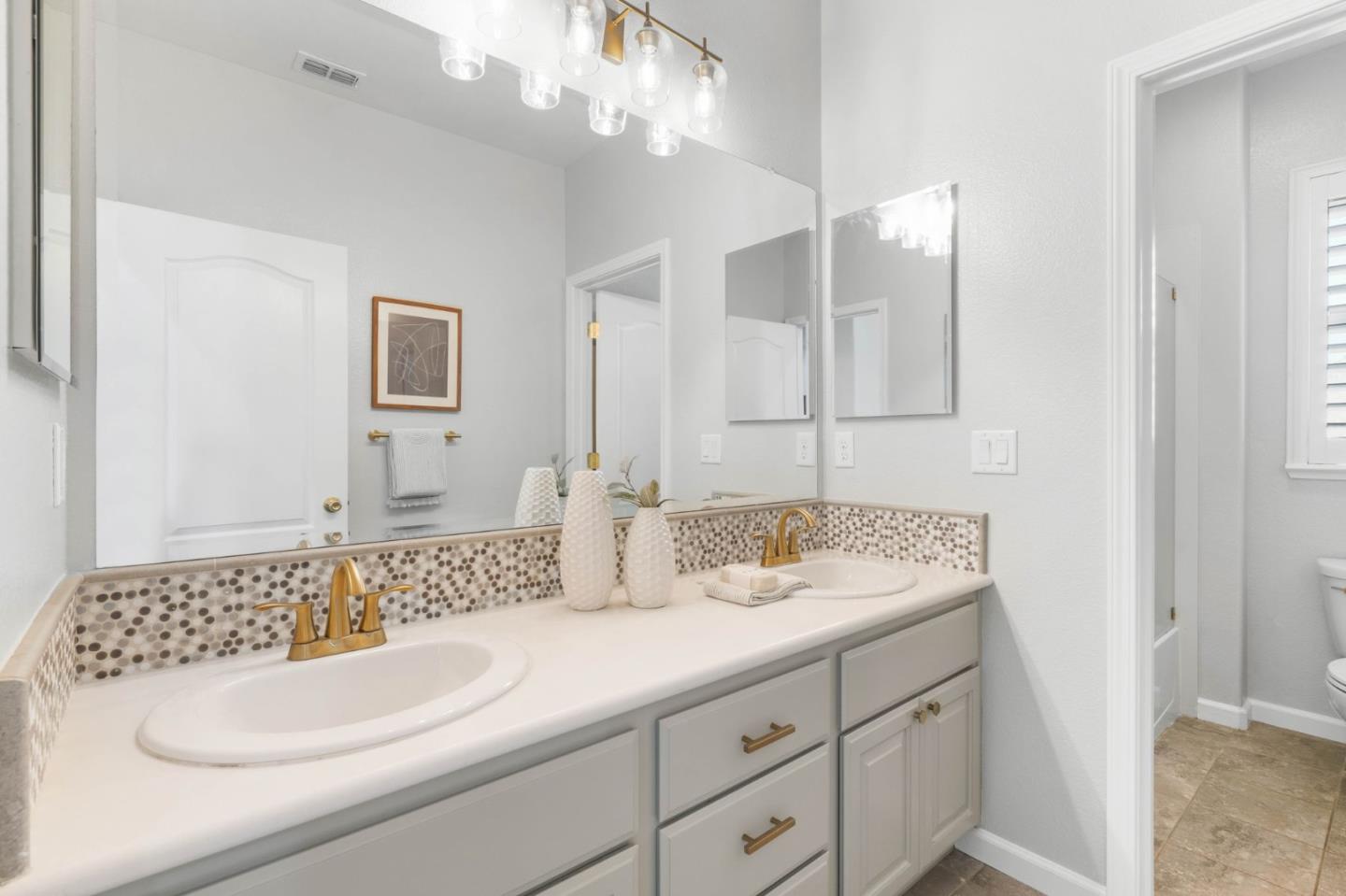 7026 Syrah Drive Dublin, CA 94568 - Photo 43 of 54 a bathroom with a sink and a mirror