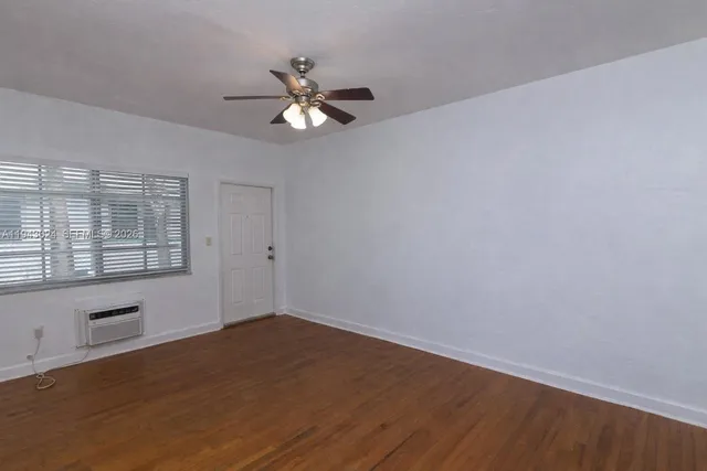 a view of a room with wooden floor and windows