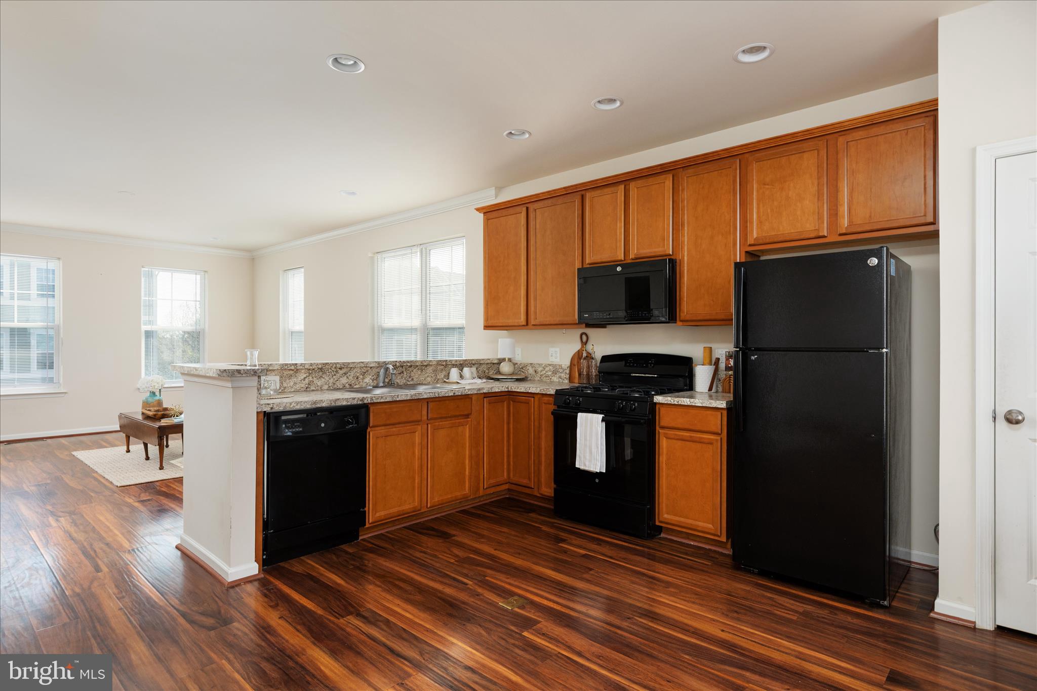 109 Splendor Garden Way Stephenson, VA 22656 - Photo 13 of 58 a kitchen with granite countertop a refrigerator stove top oven and sink
