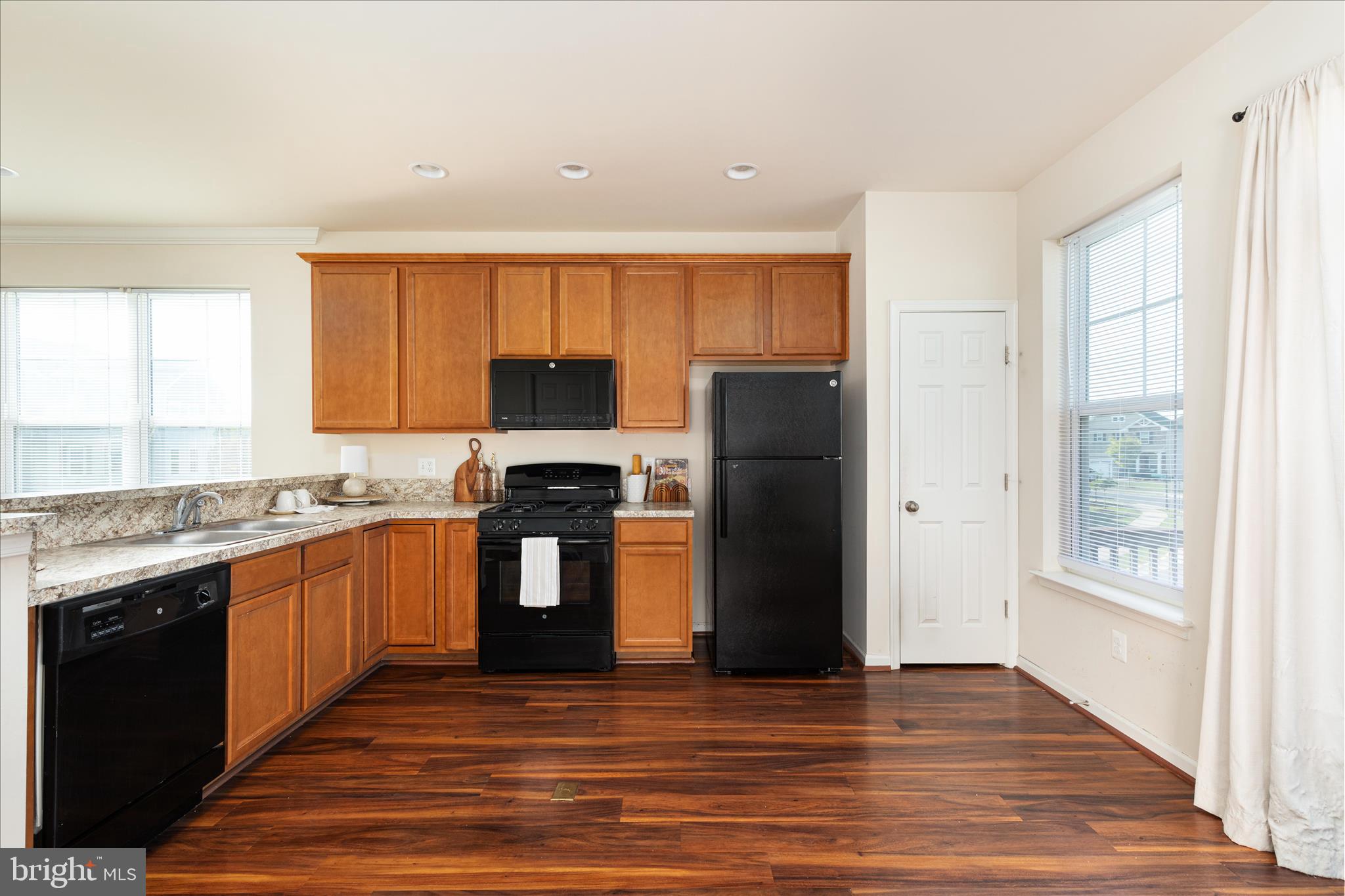 109 Splendor Garden Way Stephenson, VA 22656 - Photo 16 of 58 a kitchen with granite countertop a refrigerator stove top oven and sink