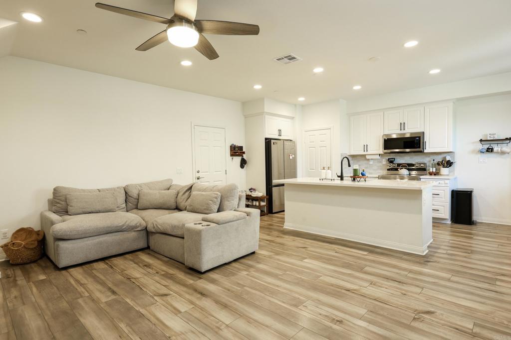 10443 Graphite Street Spring Valley, CA 91977 - Photo 12 of 18 a living room with furniture and a wooden floor