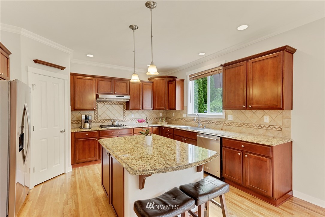 21909 39th Drive Southeast Bothell, WA 98021 - Photo 12 of 26 a kitchen with stainless steel appliances granite countertop a sink stove and refrigerator