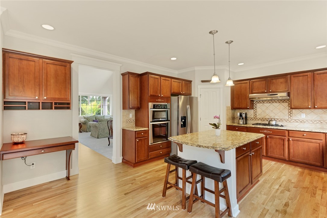 21909 39th Drive Southeast Bothell, WA 98021 - Photo 13 of 26 a large kitchen with kitchen island a large counter top space a sink stainless steel appliances and cabinets