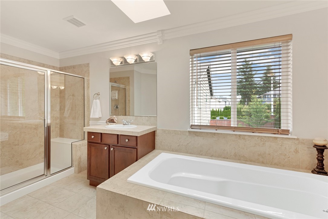 21909 39th Drive Southeast Bothell, WA 98021 - Photo 19 of 26 a bathroom with a tub sink shower and mirror