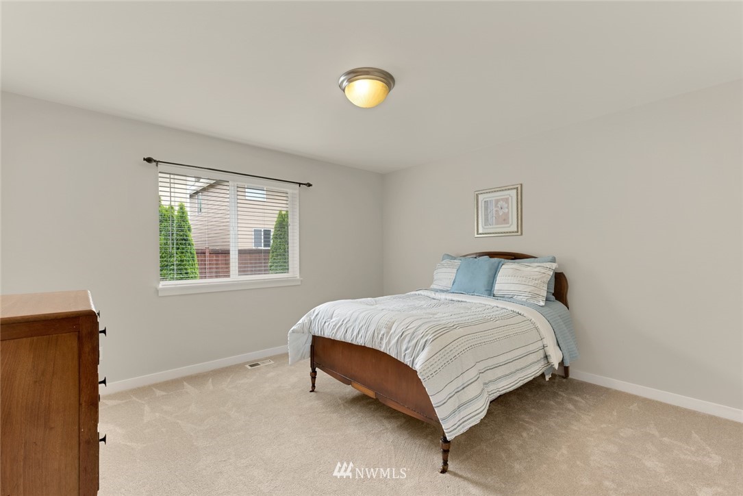 21909 39th Drive Southeast Bothell, WA 98021 - Photo 20 of 26 a bedroom with a bed and a window