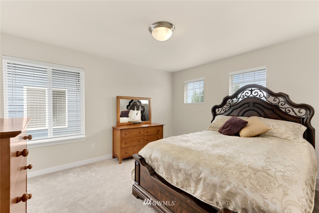21909 39th Drive Southeast Bothell, WA 98021 - Photo 21 of 26 a bedroom with a bed and a dresser next to a window