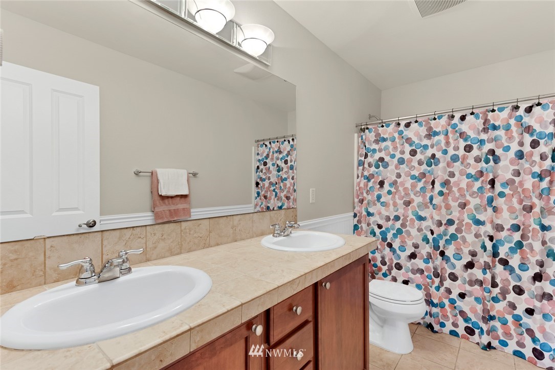 21909 39th Drive Southeast Bothell, WA 98021 - Photo 22 of 26 a bathroom with a sink and a mirror