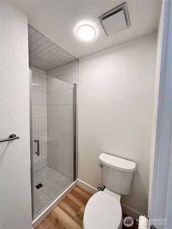 a bathroom with a toilet and a shower