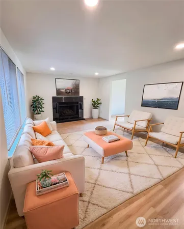 a living room with furniture a rug and a flat screen tv