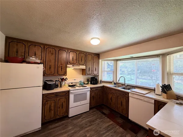 a kitchen with a sink stove and refrigerator