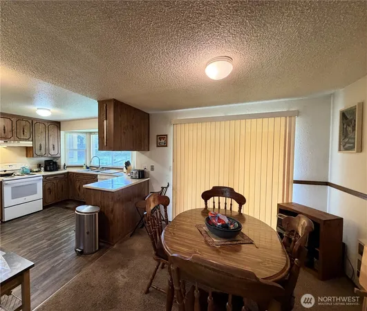 a view of a dining room with furniture and window