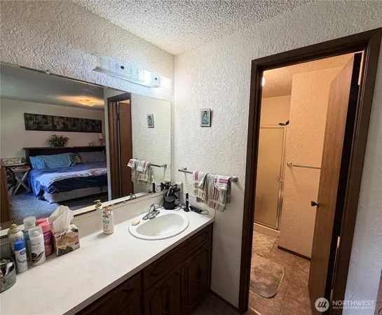 a bedroom with bed chair and window