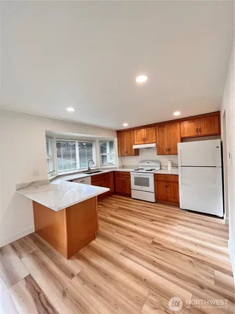 a kitchen with stainless steel appliances granite countertop a stove and a sink