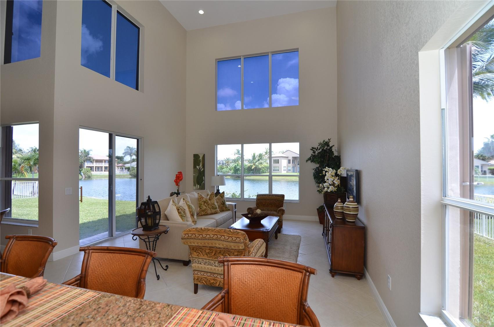 18602 Southwest 49th Street Miramar, FL 33029 - Photo 12 of 29 a living room with furniture two windows and a flat screen tv