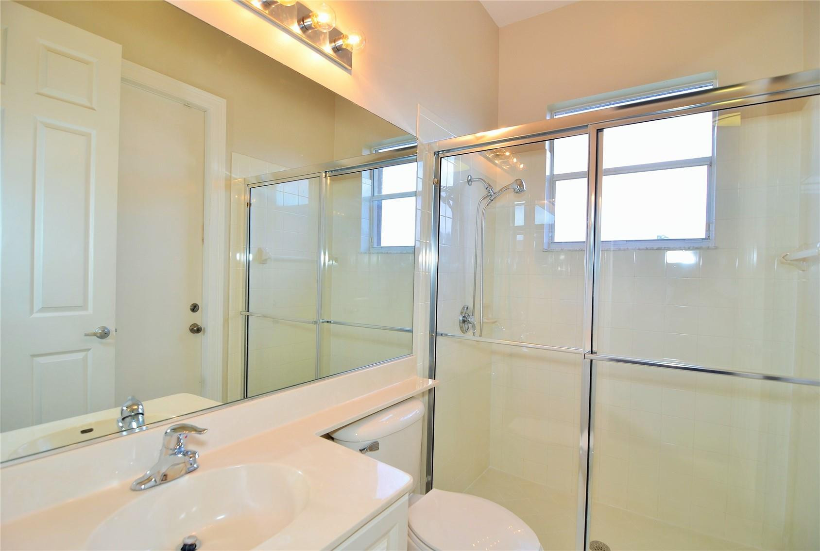 18602 Southwest 49th Street Miramar, FL 33029 - Photo 18 of 29 a bathroom with a sink toilet and shower