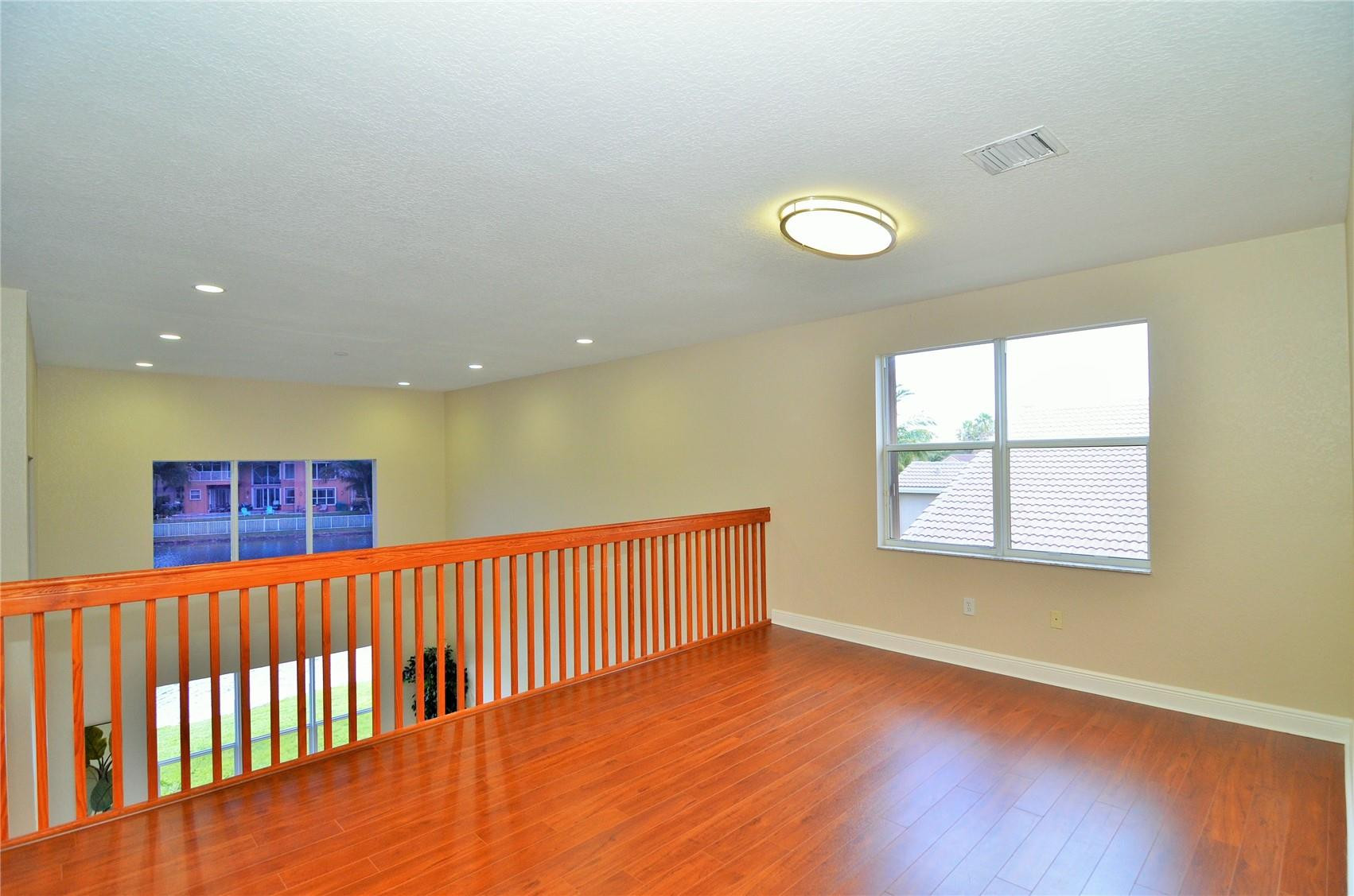 18602 Southwest 49th Street Miramar, FL 33029 - Photo 19 of 29 a view of a hallway with a window and wooden floor