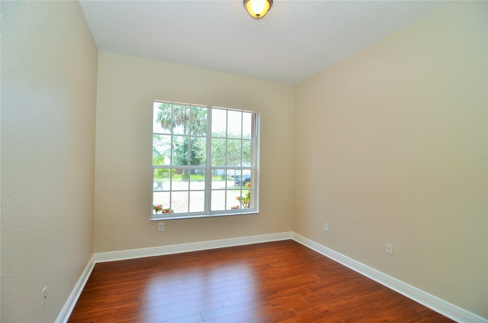 18602 Southwest 49th Street Miramar, FL 33029 - Photo 23 of 29 an empty room with wooden floor and windows