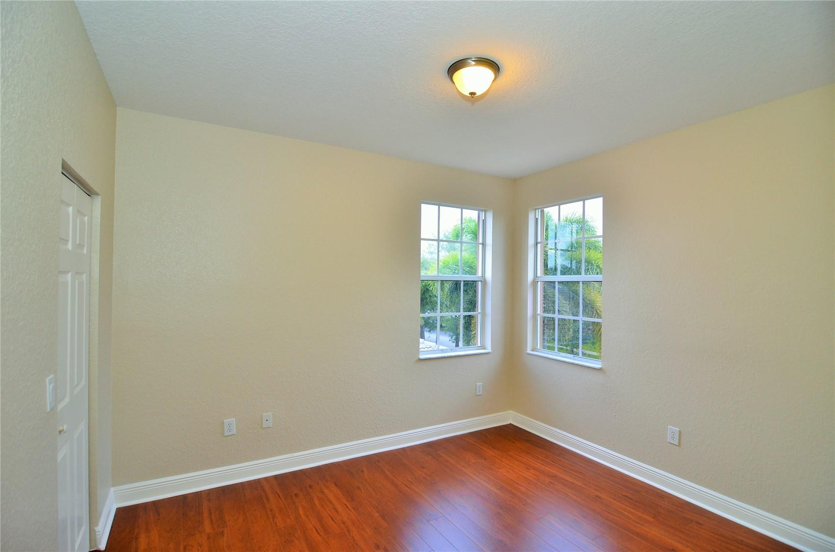 18602 Southwest 49th Street Miramar, FL 33029 - Photo 24 of 29 an empty room with wooden floor and windows