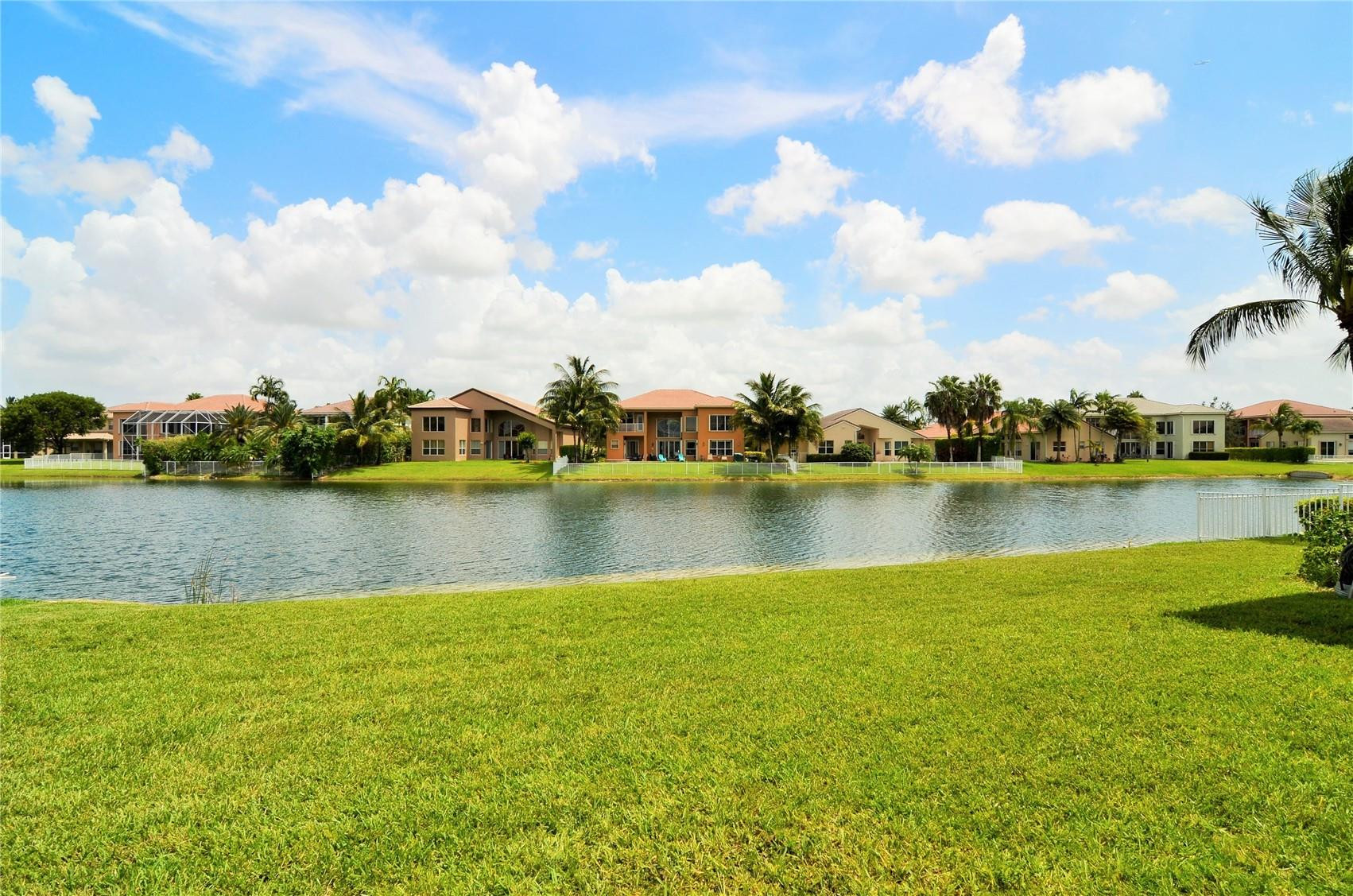 18602 Southwest 49th Street Miramar, FL 33029 - Photo 25 of 29 a view of a lake with houses in the back