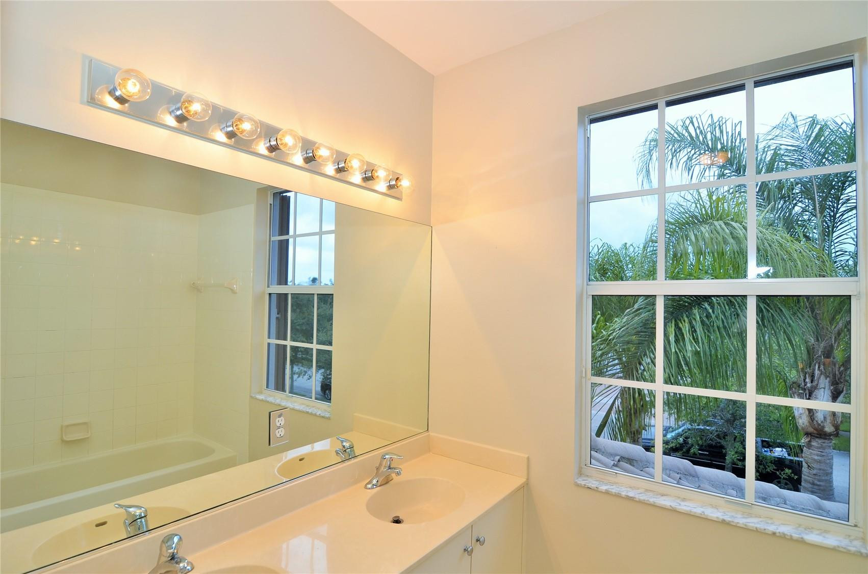 18602 Southwest 49th Street Miramar, FL 33029 - Photo 29 of 29 a bathroom with a tub sink and mirror