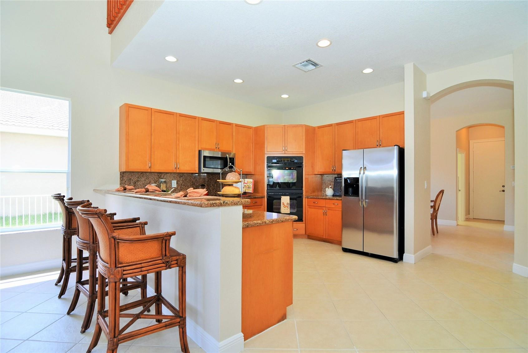 18602 Southwest 49th Street Miramar, FL 33029 - Photo 3 of 29 a kitchen with stainless steel appliances a refrigerator and a stove top oven