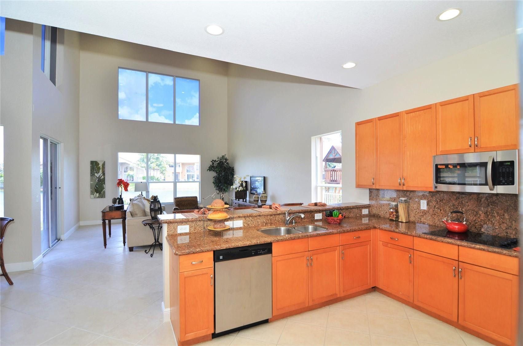 18602 Southwest 49th Street Miramar, FL 33029 - Photo 4 of 29 a kitchen with stainless steel appliances granite countertop a sink stove and cabinets