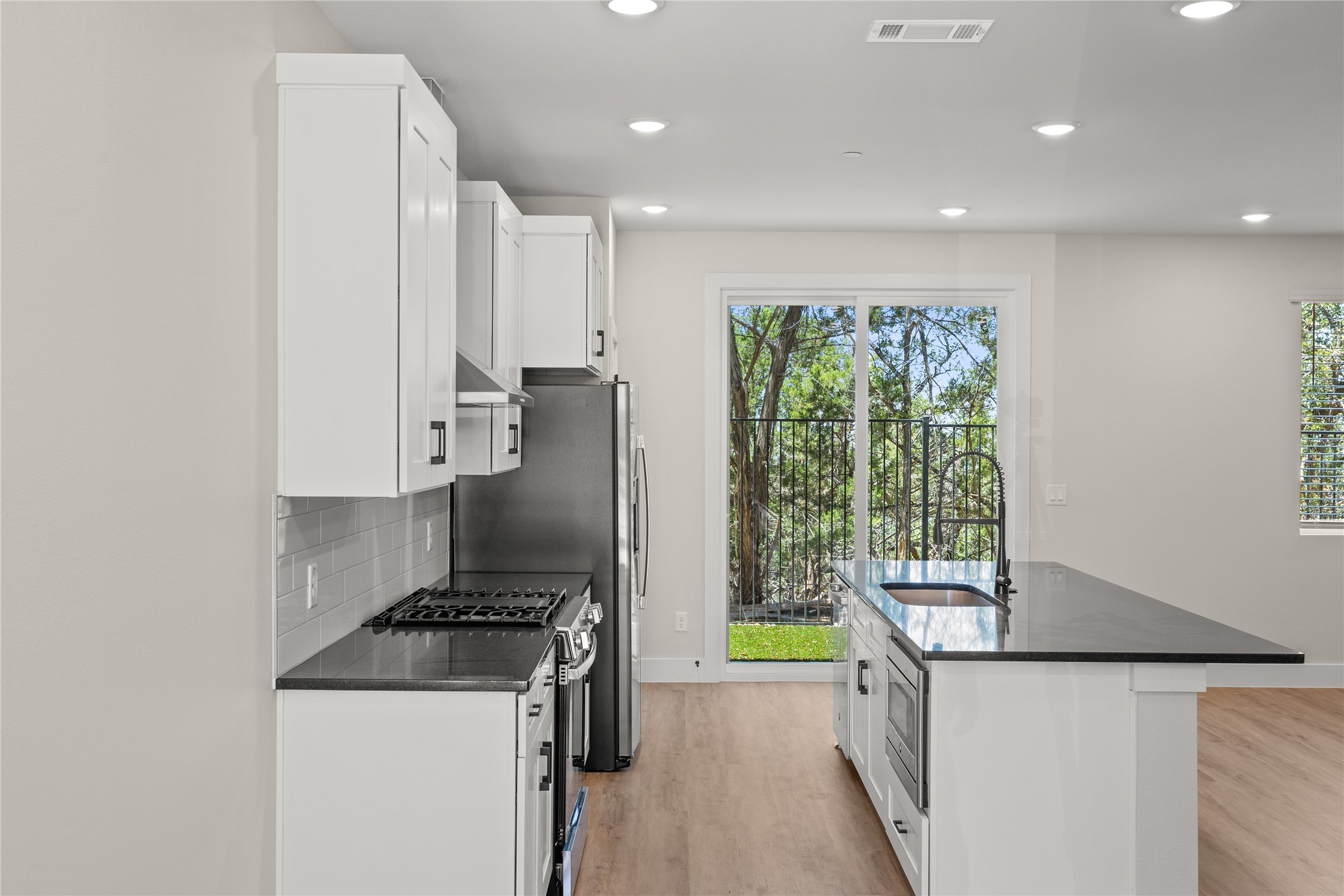 5514 Mobeetie Loop Bee Cave, TX 78738 - Photo 5 of 20 a kitchen with stainless steel appliances granite countertop a stove and a refrigerator