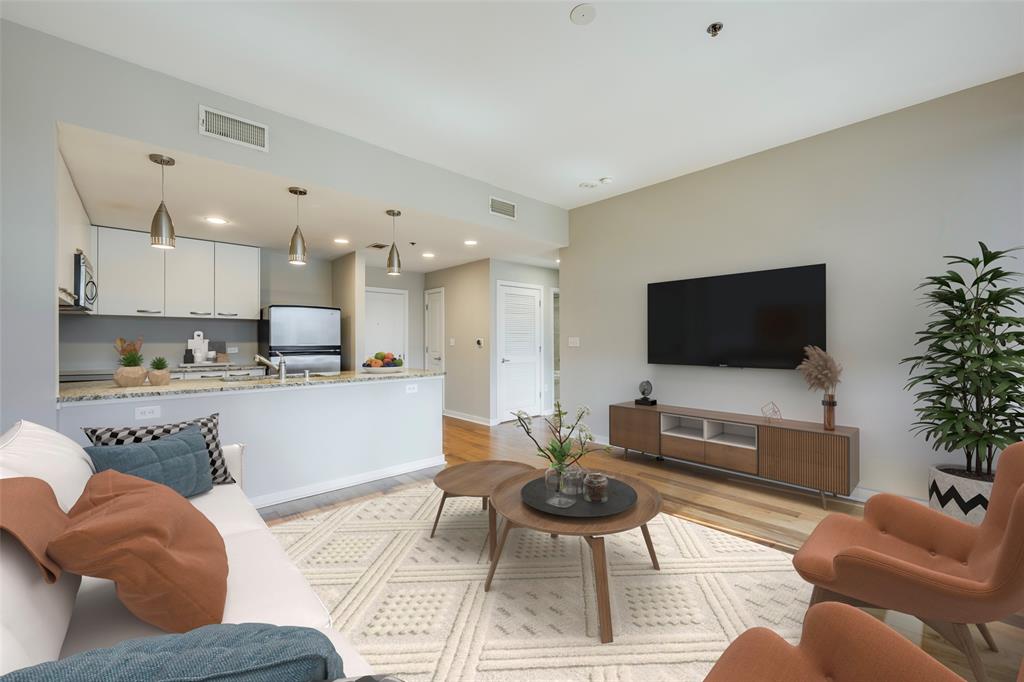 1200 Main Street, Unit 1002 Dallas, TX 75202 - Photo 11 of 30 a living room with furniture and a flat screen tv