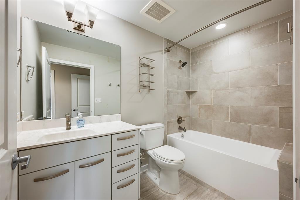 1200 Main Street, Unit 1002 Dallas, TX 75202 - Photo 23 of 30 a bathroom with a sink a toilet and shower