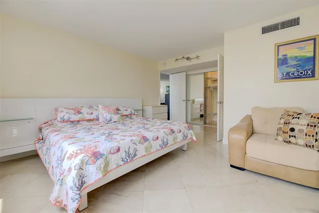 a bedroom with a bed and a couch