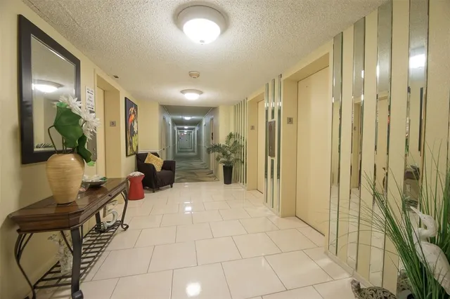 a lobby with furniture and a glass door shower