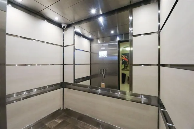 a front view of a house with a yard and palm trees