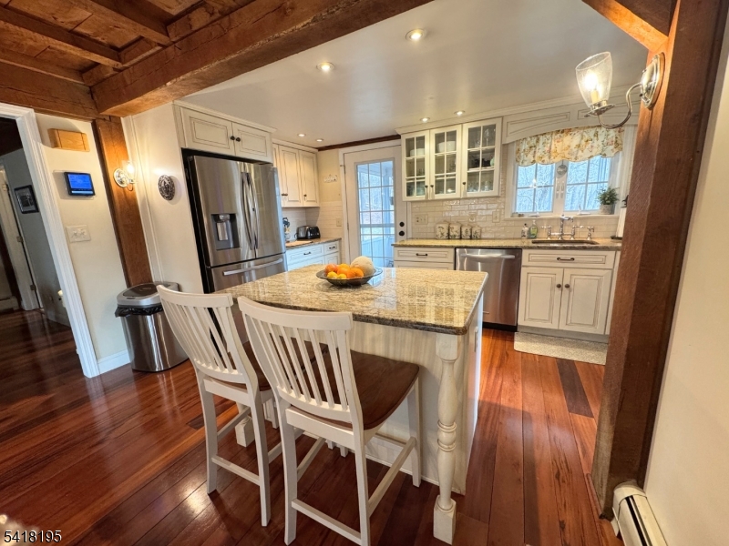 60 Plotts Road Newton, NJ 07860 - Photo 11 of 36 a view of a dining room with furniture a rug and wooden floor