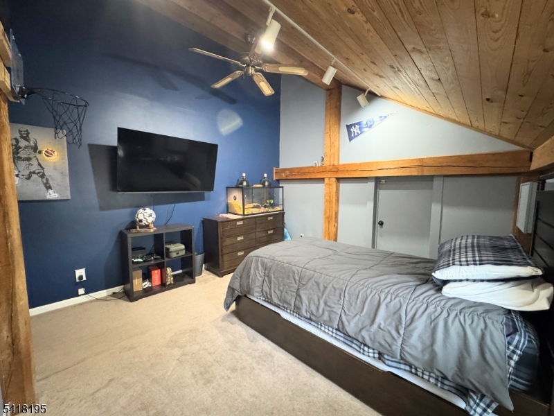 60 Plotts Road Newton, NJ 07860 - Photo 22 of 36 a bedroom with a bed and a flat tv screen on dresser