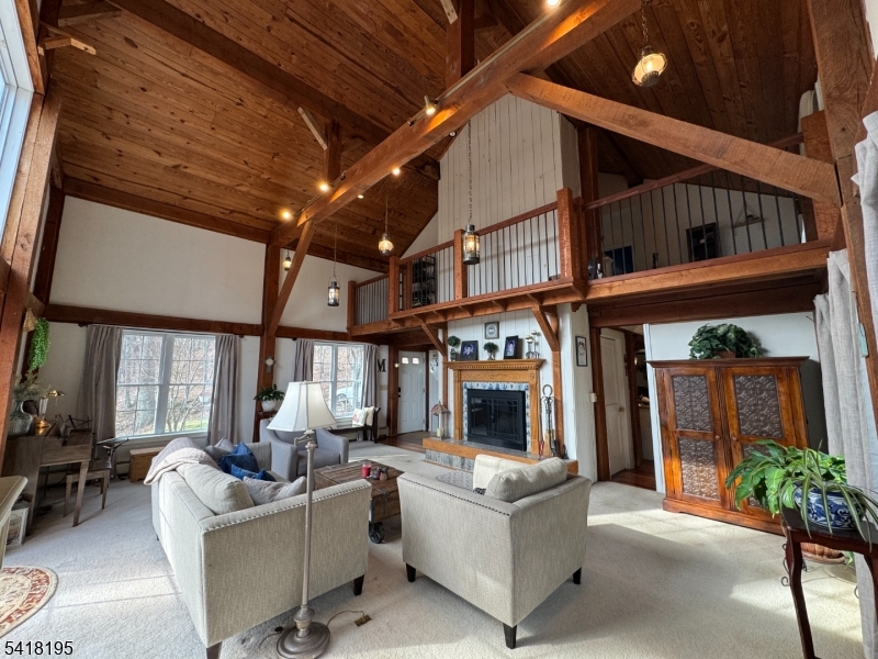 60 Plotts Road Newton, NJ 07860 - Photo 5 of 36 a living room with furniture a fireplace and a large window
