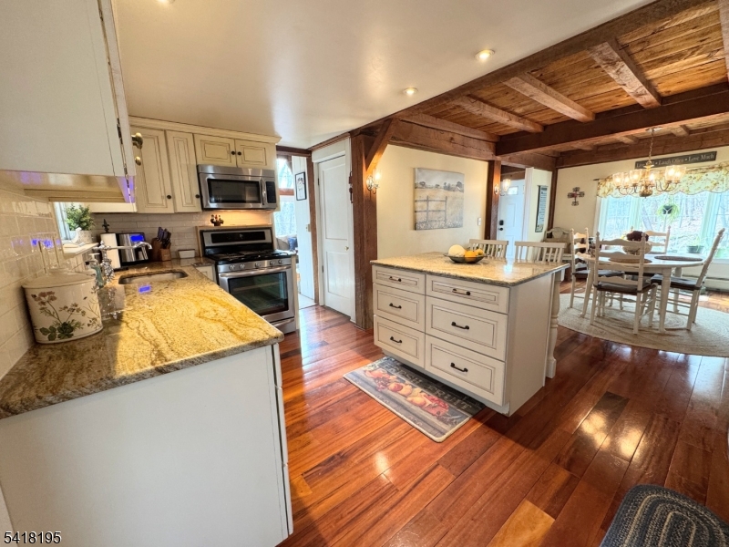 60 Plotts Road Newton, NJ 07860 - Photo 9 of 36 a kitchen with stainless steel appliances granite countertop a sink stove and wooden cabinets