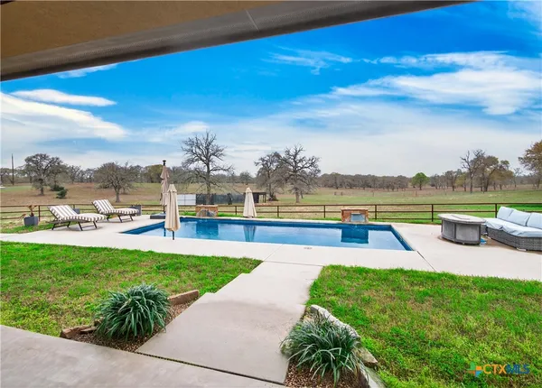 a view of a swimming pool with an outdoor seating