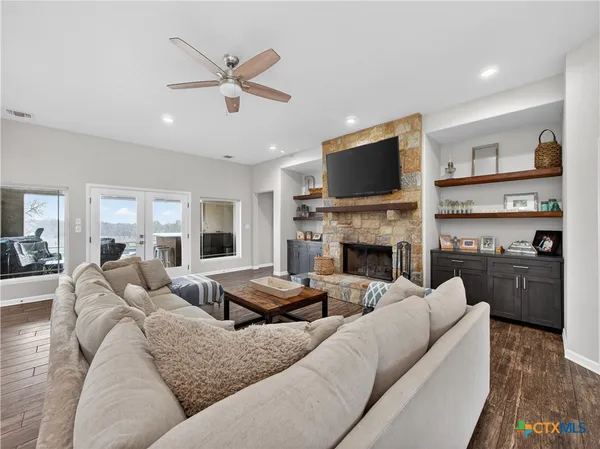 a living room with furniture fireplace and a flat screen tv