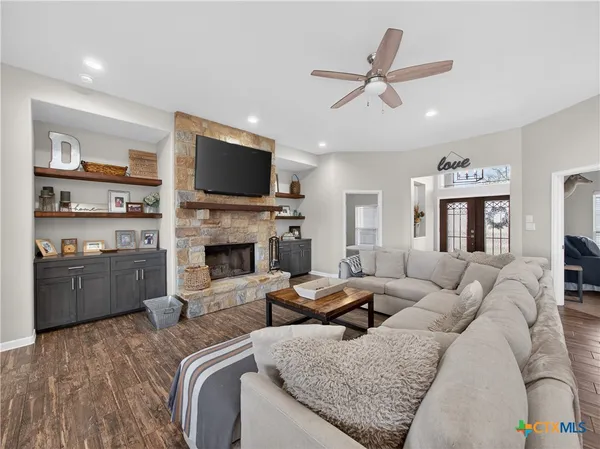 a living room with furniture fireplace and flat screen tv