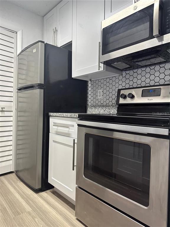 241 Afton Square, Unit 205 Altamonte Springs, FL 32714 - Photo 3 of 32 a kitchen with granite countertop cabinets and steel stainless steel appliances