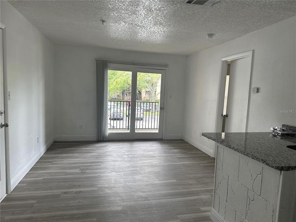 241 Afton Square, Unit 205 Altamonte Springs, FL 32714 - Photo 4 of 32 wooden floor in an empty room with a window