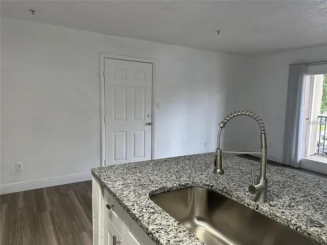 a kitchen with a sink and granite top