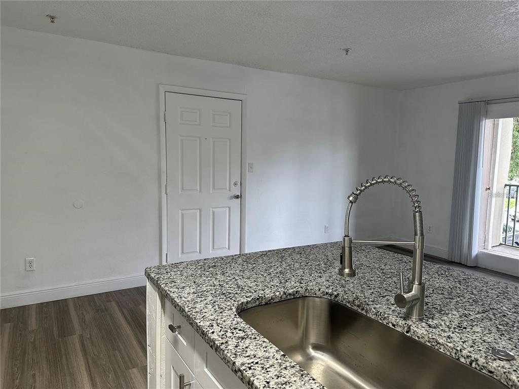 241 Afton Square, Unit 205 Altamonte Springs, FL 32714 - Photo 5 of 32 a kitchen with a sink and granite top