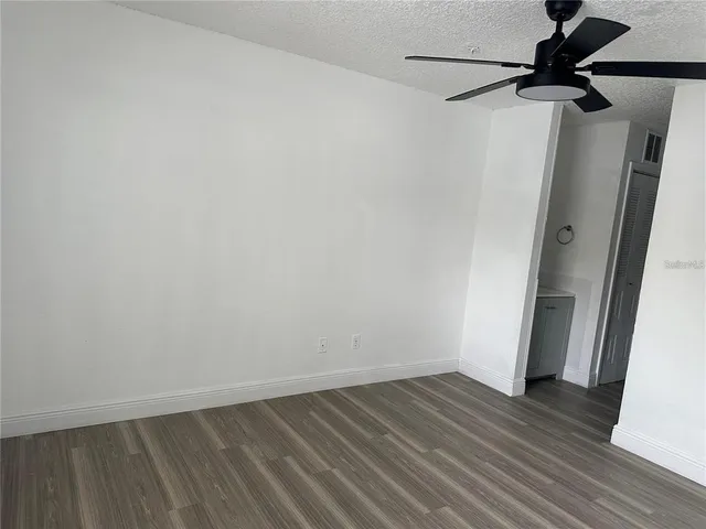 a view of a room with wooden floor and a sink