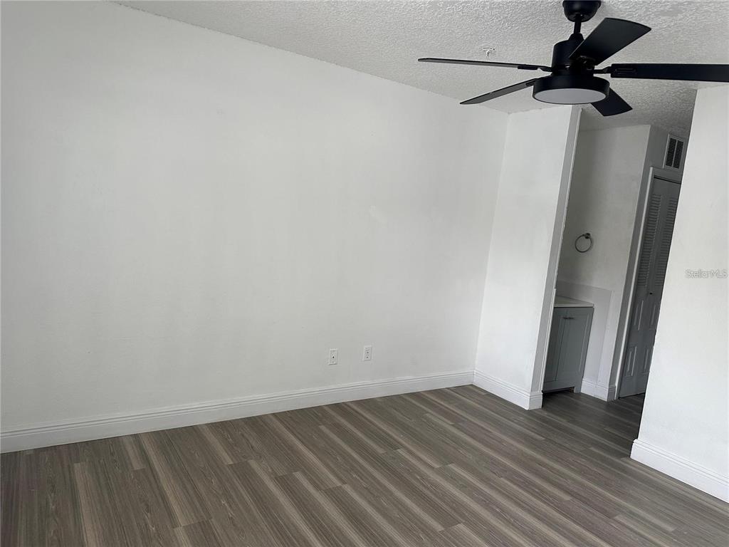 241 Afton Square, Unit 205 Altamonte Springs, FL 32714 - Photo 7 of 32 a view of a room with wooden floor and a sink