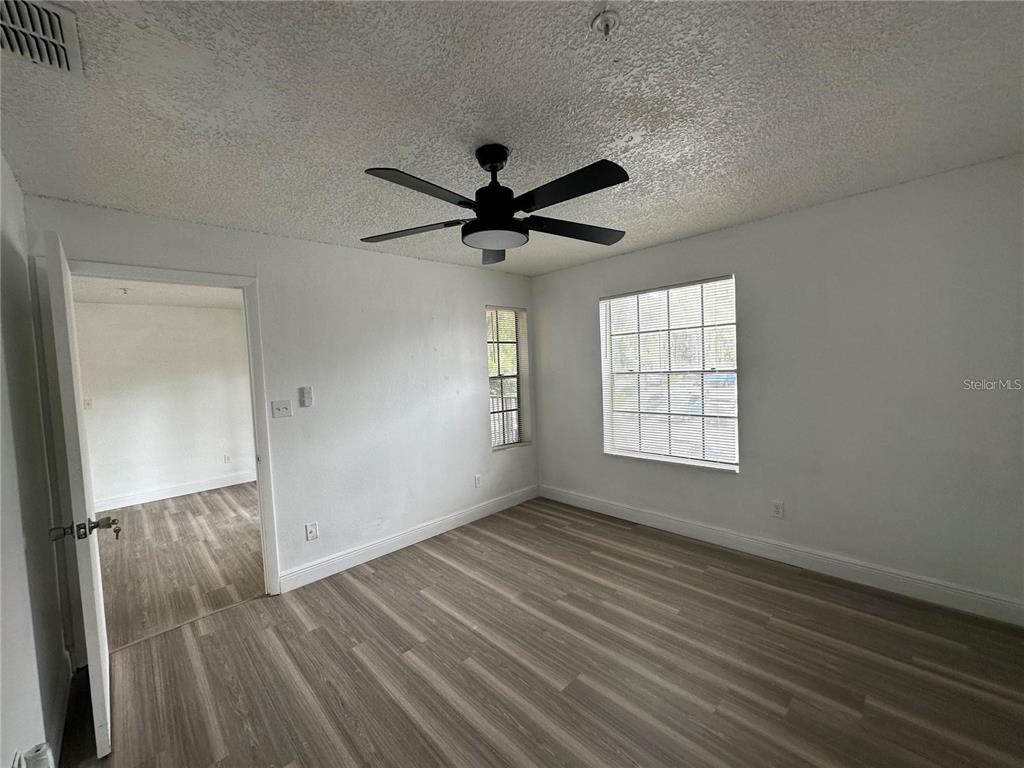 241 Afton Square, Unit 205 Altamonte Springs, FL 32714 - Photo 8 of 32 wooden floor in an empty room with a window